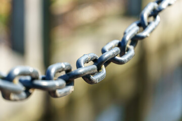 An old rusty anchor chain. Fixing the boat on the pier. Rusty iron construction.