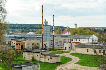 the territory of an old factory. Old brick boiler house buildings with high-protruding pipes.