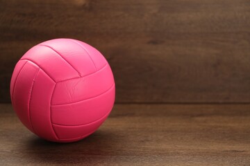 One volleyball ball on wooden table, space for text