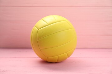 One volleyball ball on pink wooden table