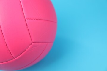 One volleyball ball on light blue background, closeup. Space for text