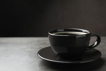 Aromatic coffee in cup on grey table, closeup. Space for text