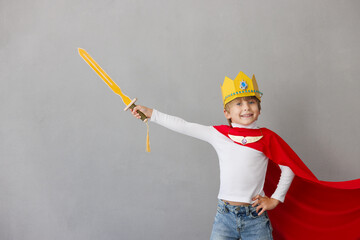 Child pretend to be knight. Kid having fun at home