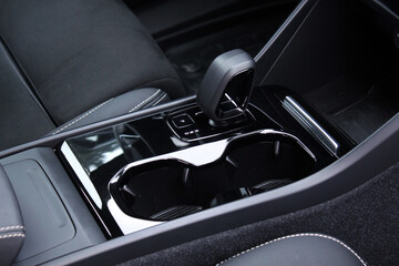 Close up electric car automatic transmission. Gear shift in new electric car. Automatic transmission with leather in the interior of a new modern car. Car Black leather interior.