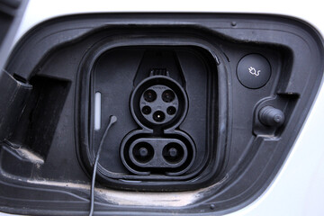 Close-up of DC charging port for electric vehicles, showcasing cutting-edge EV technologies and energy solutions. A clean mobility concept promoting sustainable transportation and innovation.