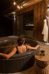 Relaxing evening in a hot tub by a cozy cabin