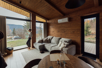 Cozy indoor scene with a woman relaxing and working on a laptop