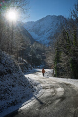 Woman walking on an icy mountain road