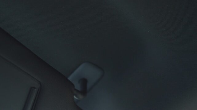 Car sun visor flipping down inside vehicle cabin with real sound