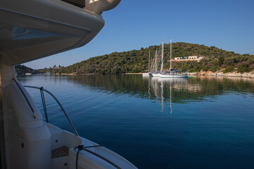 Moored sailboats on the coast of Atherinos Bay, Meganisi island, Ionian Sea, Greece in the summer morning.