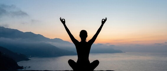 Silhouette meditating at sunrise over sea and mountains