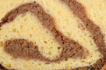 Detailed macro shot showing the beautiful swirls of sweet walnut filling inside a soft and fluffy homemade yeast dough