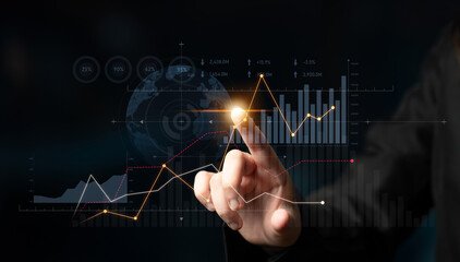 A business professional interacts with digital financial data, showcasing graphs and trends to...
