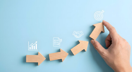 business growth concept with wooden arrows and hand