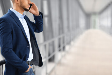Mobile Call. Young Arab Businessman Talking On Cellphone At Airport Terminal, Unrecognizable Middle...