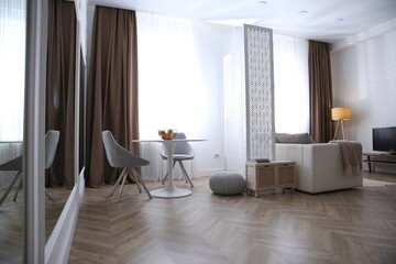 Modern living room with parquet floor and stylish furniture