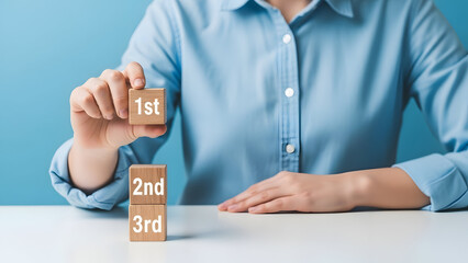 Person stacking wooden blocks with numbers on them in a prioritization concept