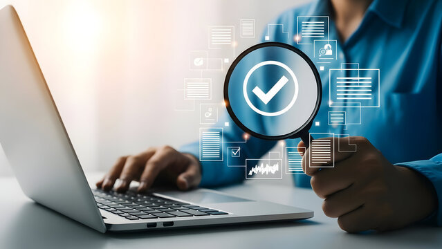 Businessman using laptop with magnifying glass and check mark icon for inspection and verification - Powered by Adobe