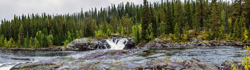 Lapland river flowing through boreal forest landscape
