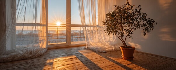 The light wood floor receives golden sunbeams through sheer curtains, and two green potted plants are positioned near floor‑to‑ceiling windows that view trees, forming a serene interior scene with