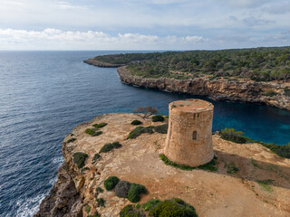 Historic watchtower overlooking the coast at Cala Pi in Mallorca, Spain