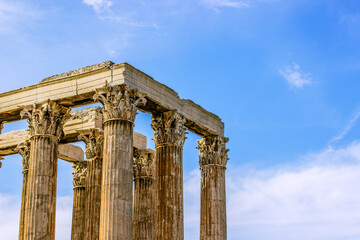 marble colonnade of ancient temple Greek abandoned ruined architecture square shape of top and pillars on blue sky background travel and sightseeing Earth concept picture