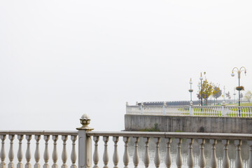 city waterfront atmospheric architecture of coast line concrete walking area minimalism style design park square in morning misty weather time gray air background of polluted town