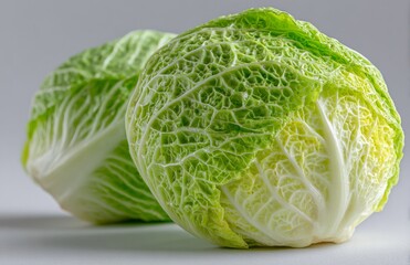 Fototapeta premium A whole green cabbage with a smooth surface and tightly packed leaves provides a fresh, crisp texture and light green color, making it ideal for healthy meals, cooking, and dietary requirements