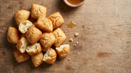 Traditional Central Asian Baursak Fried Dough Puffs on Rustic Wooden Table with Honey