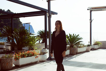 pretty young woman on stylish promenade at seaside, lifestyle people concept