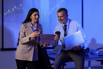 Business analysts with coffee working in dark office. Data science concept