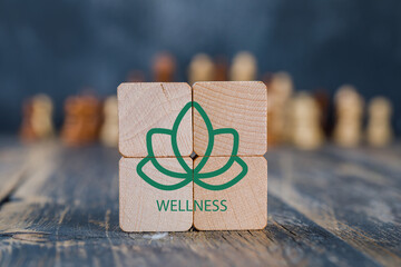Wellness symbol on wooden blocks. A minimalist image featuring four wooden blocks arranged to form...