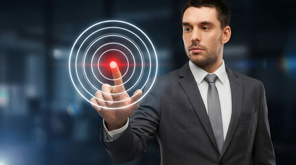Professional man in a suit touching a glowing virtual target interface in a dark futuristic office environment with focused intensity