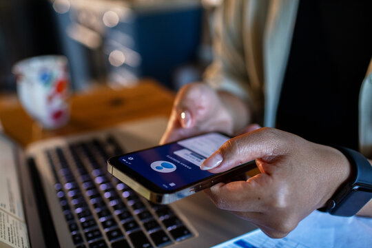 Adult focused texting on smartphone at home office