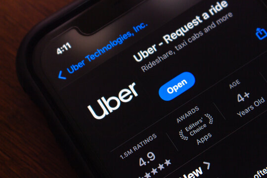 Quito, ECUADOR - Oct 13 2025 : Close-up of a smartphone displaying the Uber app page in the App Store, showing logo, rating, and download options.