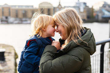 Grandmother and child sharing affectionate moment outdoors in London