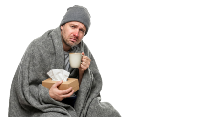 Person with a cold covered with a blanket holding a cup and tissues while looking unwell isolated on white background during the day