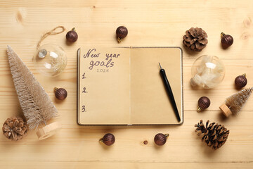 Notebook with empty to do list, pen and Christmas decor on wooden background. New Year Goals 2026