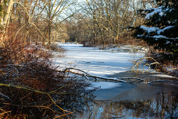 snow-covered river winds through a winter forest