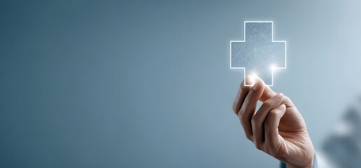 A human hand holding or reaching for a white medical cross symbol on a solid blue background