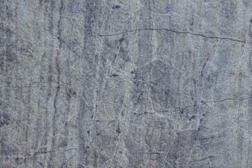 Obraz premium Textured gray stone surface with natural patterns, showcasing intricate lines and variations, ideal for backgrounds, design projects, and artistic applications in various contexts