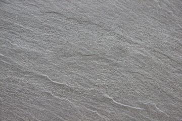Fototapeta premium Textured gray surface with subtle patterns and natural lines, showcasing the beauty of stone material, ideal for backgrounds and design projects with copy space