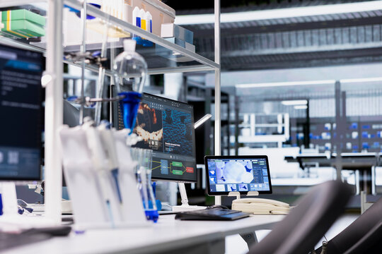 Laboratory workstation and tablet display DNA visualization software used to process patient data for clinical research. Digital interface used for genetic analysis diagnostics in laboratory - Powered by Adobe