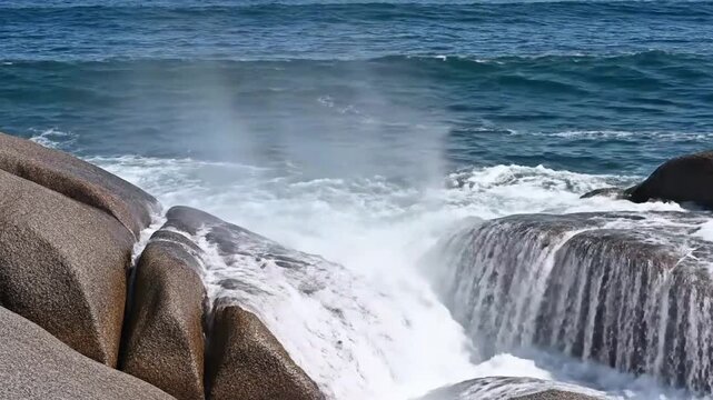 Powerful Ocean Waves Crashing Against Rocky Shoreline During Stormy Weather.