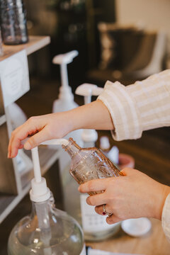 Hands Refilling Containers