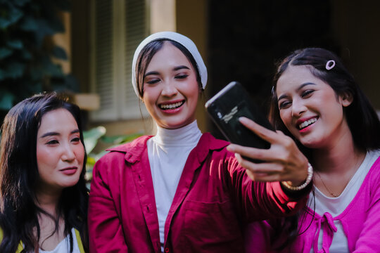 Radiant trio captures joyful moments, Asian women's laughter ech