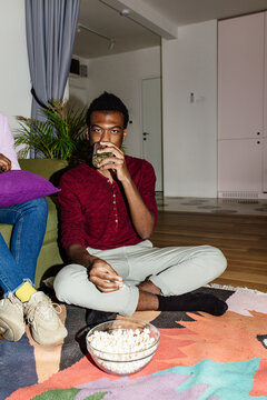 Man drinking on the floor