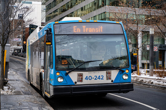 City bus STM in transit on downtown Montreal street in winter. Montreal, Canada - December 18, 2025.