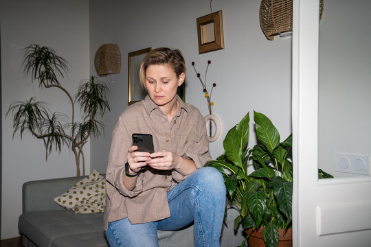 Woman Using Smartphone in Living Room