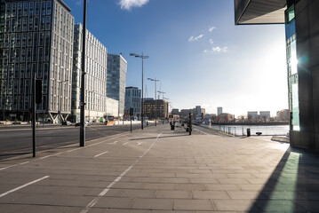 Winter afternoon on Liverpool waterfront shows promenade and cycle lane by River Mersey, Pier Head...